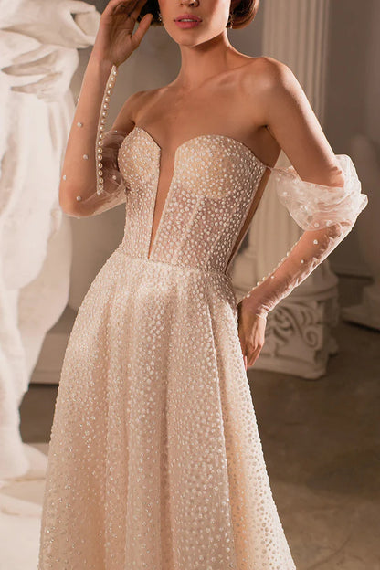 A charming deep V-neck bohemian beach wedding dress paired with a court train