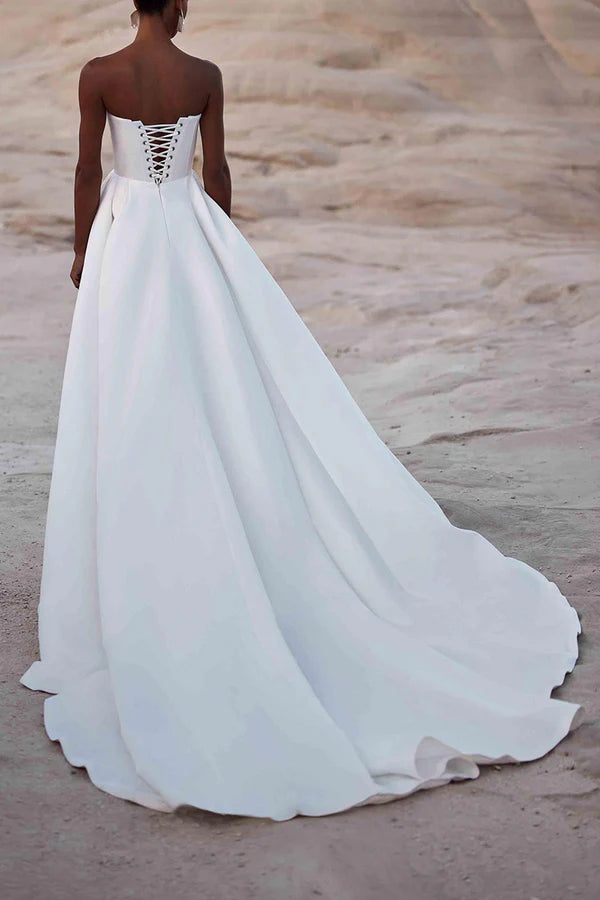 A white satin wedding dress with palace train lines and no shoulder straps