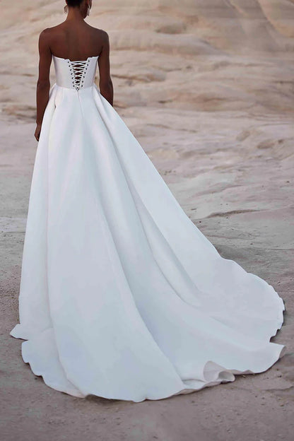 A white satin wedding dress with palace train lines and no shoulder straps