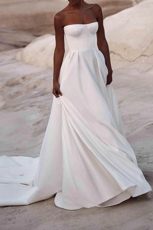 A white satin wedding dress with palace train lines and no shoulder straps